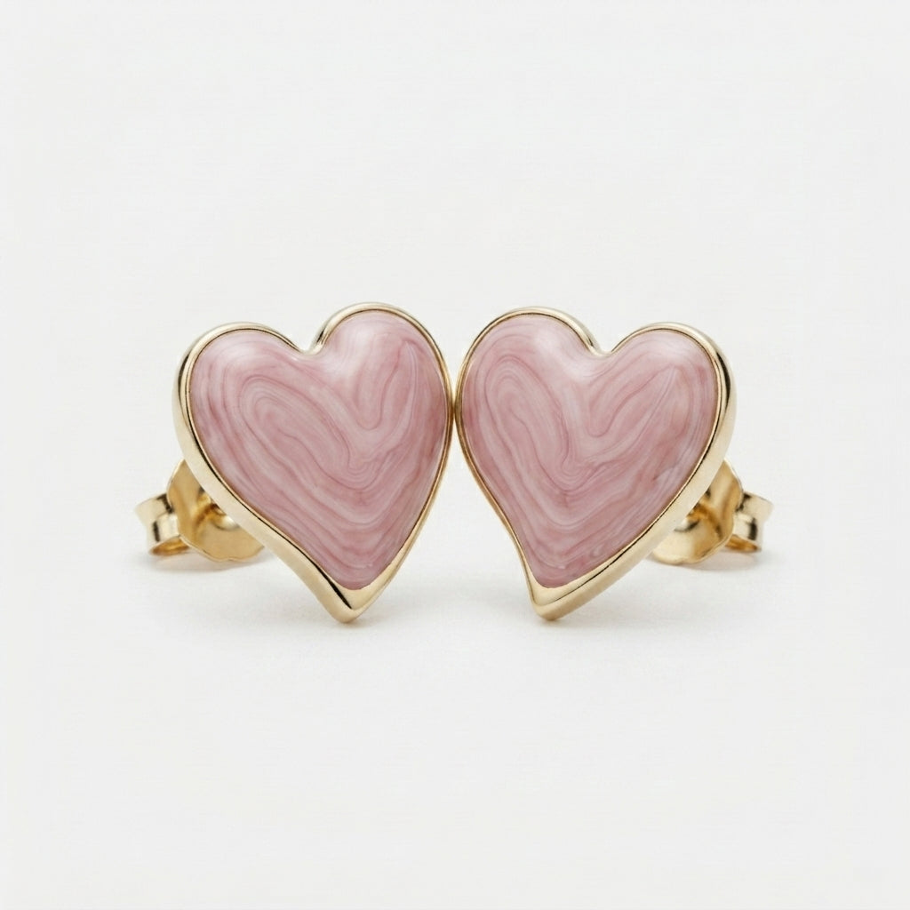 Four-panel product collage showing heart-shaped stud earrings with pink marbled inlay and polished gold-tone edges and posts, including front views, side views, and a close-up detail shot on a light gray background.