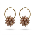 A pair of gold hoop earrings with dangling flower-shaped charms made of faceted taupe beads, shown on a clean white background.