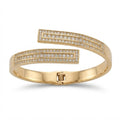 A gold-plated open cuff bangle bracelet with pavé-set clear stones on both ends, displayed on a clean white background.