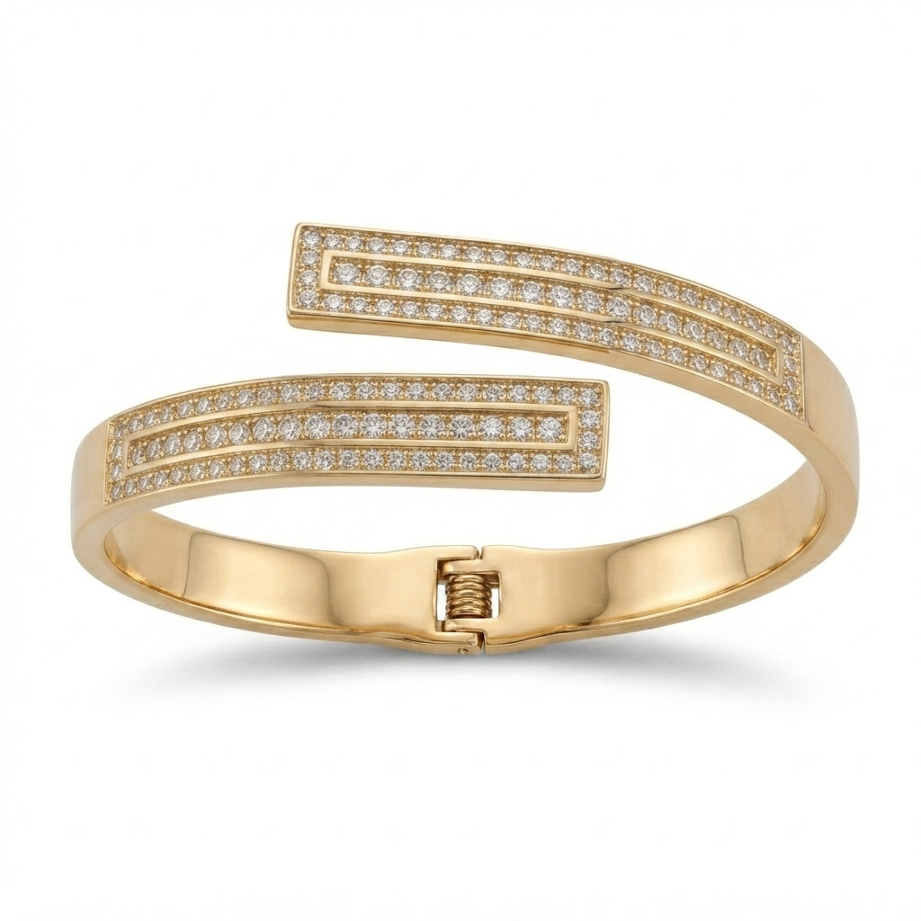 A gold-plated open cuff bangle bracelet with pavé-set clear stones on both ends, displayed on a clean white background.