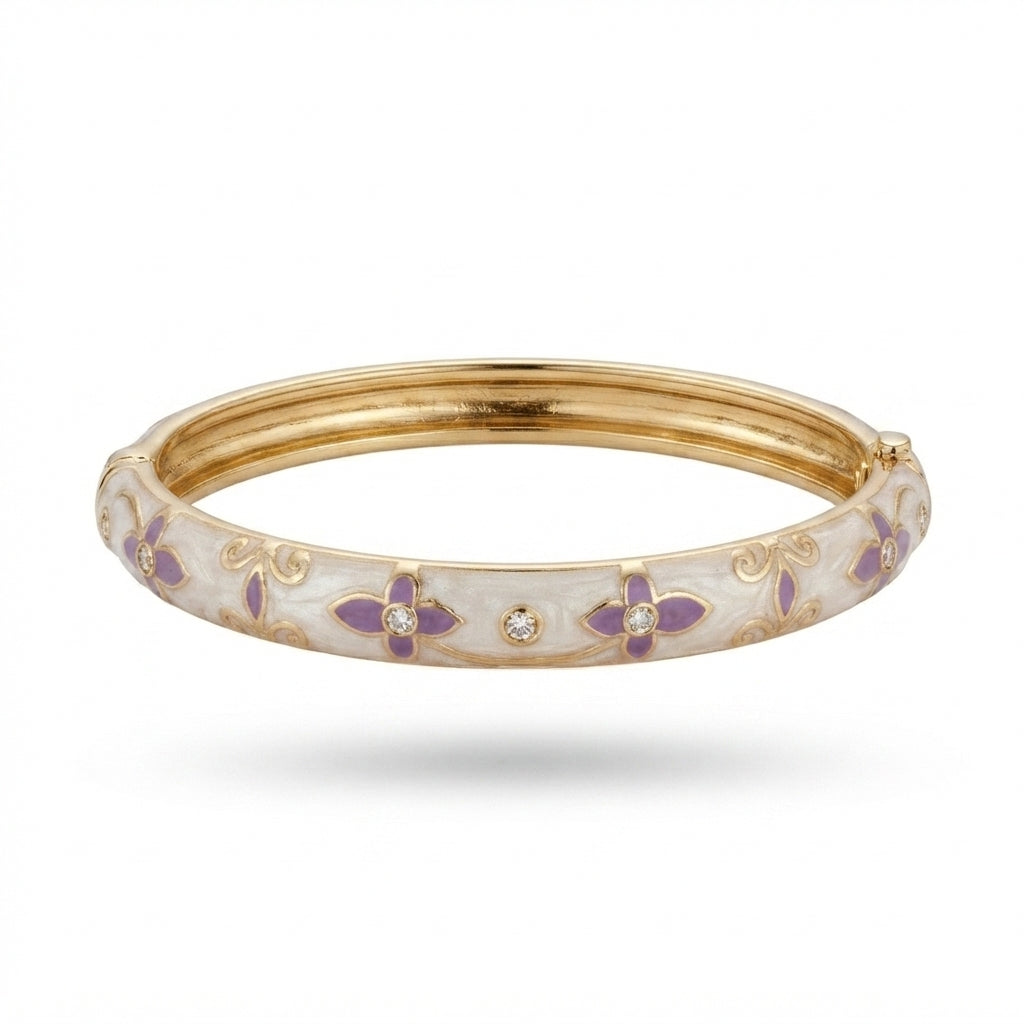 A gold-plated hinged bangle bracelet with a white enamel outer band decorated with purple floral motifs and small clear rhinestones, shown against a plain white background.