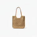 A natural woven straw tote bag with tan leather shoulder straps, shown against a plain white background.