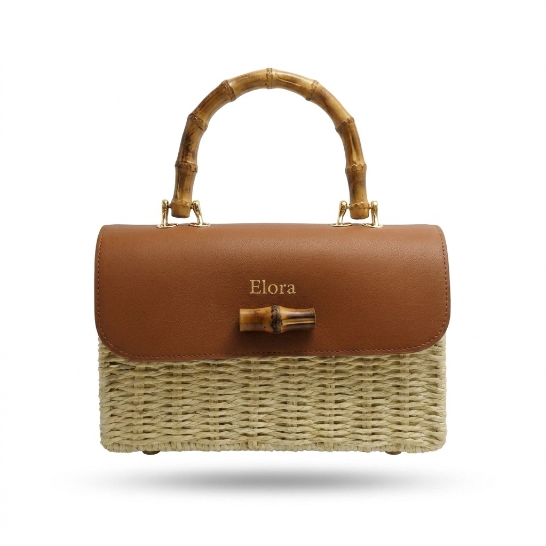 A structured handbag with a brown leather top flap featuring the name 'Elora' in gold lettering, a natural woven straw body, and a bamboo handle with gold hardware, shown against a plain white background.